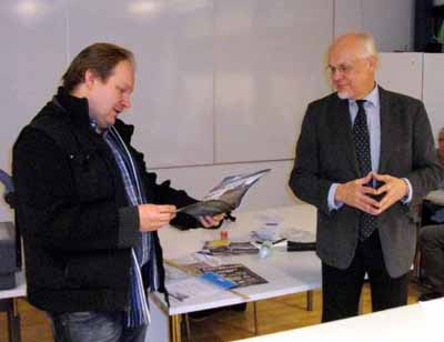 Upon receiving FoMA's Certificate of Honor from Chairman Raine Haikarainen, Tuomas Kuosmanen (at left) told the audience about the photographs in the new FoMA wall calendar 2011.